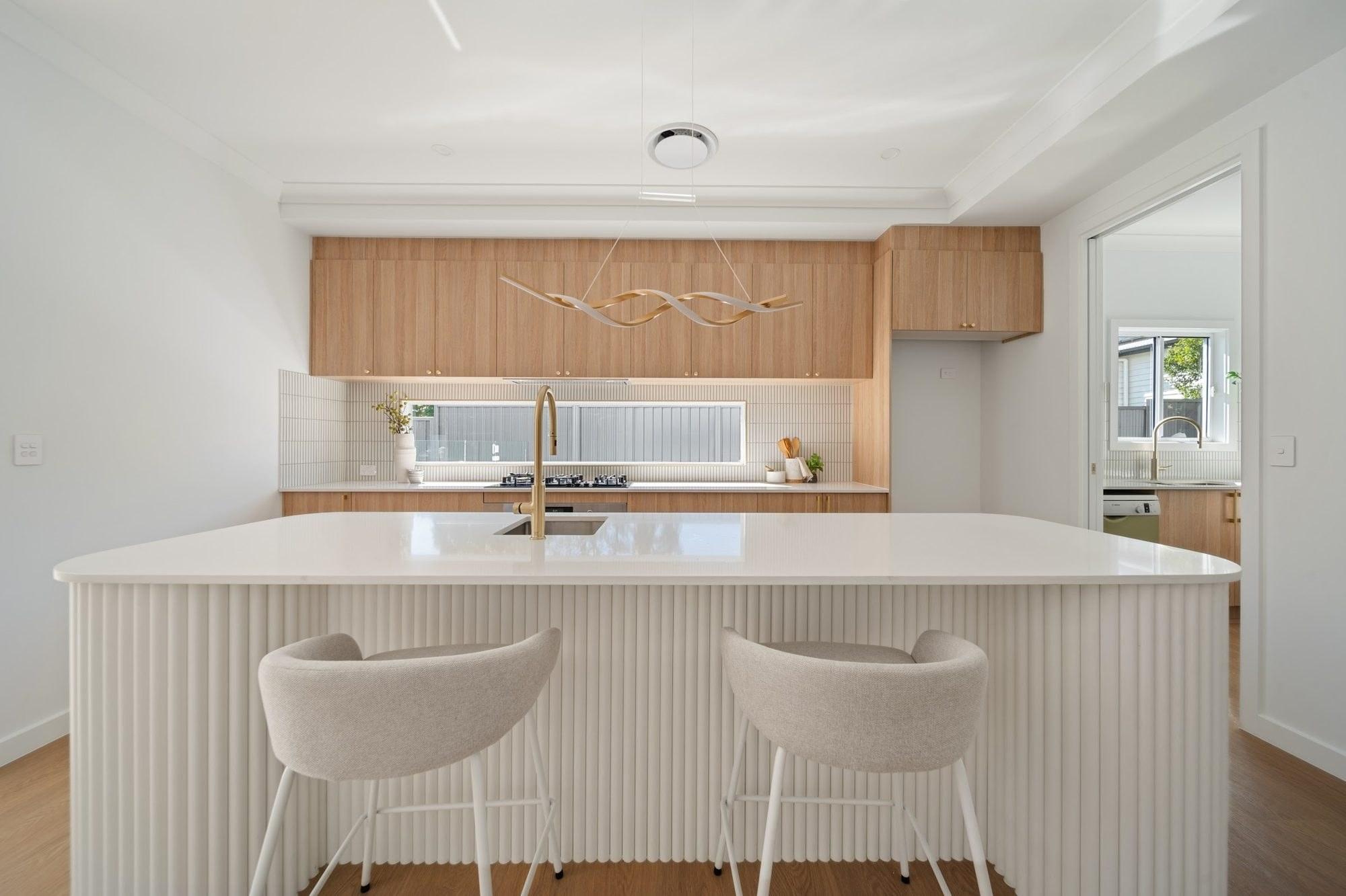 Contemporary kitchen with a curved white island